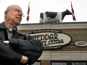 Jacques Leury, manager of Cheddar et Cetera, is fighting to keep his cow on the roof above his Orleans cheese shop after the city told him to take it down. (DARREN BROWN Ottawa Sun file photo)