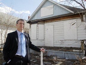 City Coun. Gord Steeves stands outside a derelict house at 736 Magnus Ave. in April 2010. (Winnipeg Sun files)