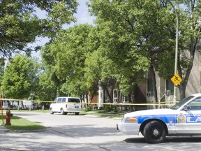 A police car is seen close to the scene of a recent shooting on Taft Crescent in which a 14-year-old boy inside a townhouse was wounded. Street-level enforcement of biker gangs is suspected. (SEBASTIEN PERTH/Winnipeg Sun)