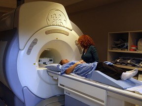 A technician at an MRI clinic preps a patient for photo purposes in February 2009. (Andre Forget, QMI Agency)