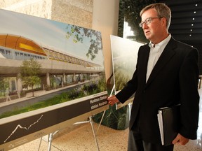 Ottawa mayor Jim Watson, looks at some conceptual drawings outside council chambers before a special meeting and vote on a revised light rail project on Thursday, July 14, 2011. City council voted unanimously to approve the plan.
(DARREN BROWN/OTTAWA SUN)