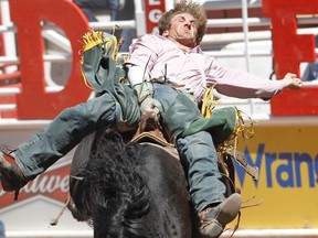 Reid Rowan of Seven Persons, Alberta rides a horse called Mad Money in the  Bareback event during the Calgary Stampede Rodeo in Calgary , Alberta, Friday July 15, 2011. AL CHAREST/CALGARY SUN/QMI AGENCY