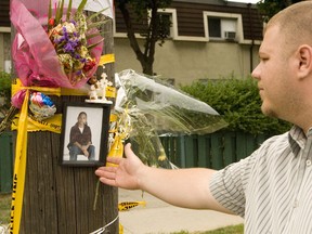 Billy Brown examines a memorial for cousin Ephraim Brown, 11, in this file photo from 2007. One of the men who was acquitted in the lad's murder was arrested Thursday by Toronto Police for allegedly trafficking crack to an undercover officer on Tuesday. (DAVE THOMAS, Toronto Sun file photo)