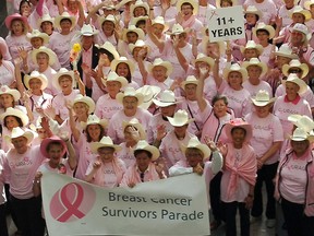 Breast cancer survivors wave to the camera as they gather to participate in the annual Breast Cancer Parade in downtown Calgary. (QMI Agency files)