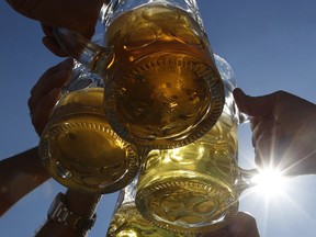 Beer steins are hoisted. (REUTERS)