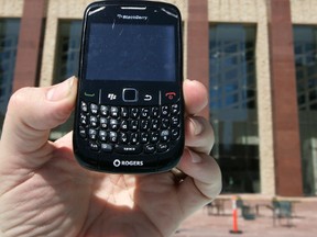 A BlackBerry is seen with City Hall in the background in Edmonton. PHOTO ILLUSTRATION BY TOM BRAID/EDMONTON SUN