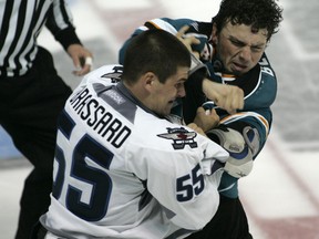 Winnipeg Jets Austen Brassard ,left, (55) takes a punch from San Jose Sharks  Zach Bell (46) during second period hockey action  at the South Okanagan Events Centre in Penticton, B.C. on September 12, 2011. The Winnipeg Jets  are playing the San Jose Sharks and are taking part in Young Stars Rookie tournament. (JEFF BASSETT/QMI Agency)