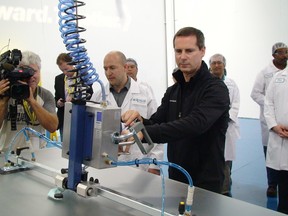 Liberal Leader Dalton McGuinty works the robot arm at Eclipsall Energy Corp., where solar PV panels are assemble. McGuinty was touting his party's Green Energy Act and job creation strategy at a campaign stop in Scarborough, September 13, 2011. (Jonathan Jenkins/QMI Agency)