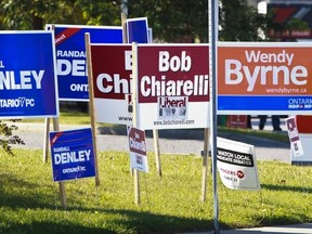 Provincial election signs litter a street corner in Ottawa West on the eve of the provincial elections, Wednesday, October 5,2011. (ERROL MCGIHON/THE OTTAWA SUN/QMI AGENCY).
