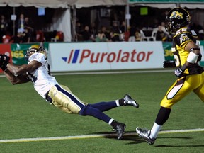 Winnipeg Blue Bombers slotback Cory Watson drops a goal line pass against Hamilton Tiger-Cats line backer Markeith Knowlton (R) during the first half of their CFL football game in Hamilton October 7, 2011.    REUTERS/Mike Cassese