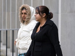 Taranjit Grewal (in black coat) leaves court with a supporter earlier in her trial. (Stan Behal/TORONTO SUN files)