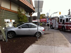 A car crashed into the Tim Hortons restaurant at 949 Corydon Ave. late Tuesday afternoon, at the intersection of Corydon and Stafford Street. (Tessa Vanderhart/Winnipeg Sun)