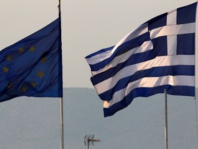 A Greek and an EU flag fly over the Greece’s finance ministry in Athens.
(REUTERS/Yannis Behrakis)
