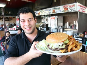Peter Scouras, owner of the Red Top Drive Inn in Winnipeg, displays a burger and fries Friday November 04, 2011. The restaurant will be taped by the Food Network next week.
BRIAN DONOGH/WINNIPEG SUN/QMI AGENCY