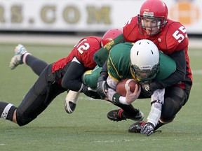 Nomads quarterback Erik Borud is tackled by Mustangs linebacker Taylor Gillespie (12) and defensive lineman Mack Hayes during a Midget Football League of Manitoba game. The Nomads will be in the season-opening game Saturday for the league that is hoping to continue to grow in popularity.