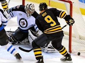 Winnipeg Jets goalie Ondrej Pavelec (31) makes a save on Buffalo Sabres center Derek Roy (9) during the first period of their NHL game in Buffalo, N.Y., on Tuesday, Nov. 8, 2011. (DON HEUPEL/REUTERS)