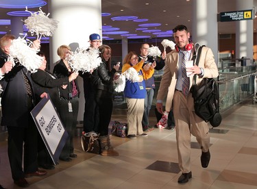 Winnipeg Blue Bombers fans and airport staff cheer as QB Buck Pierce prepared to leave Winnipeg Richardson International Airport to play in the CFL Grey Cup in Vancouver. (JASON HALSTEAD, Winnipeg Sun)