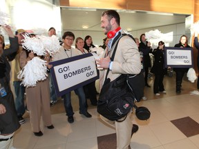 Winnipeg Blue Bombers fans and airport staff cheer as QB Buck Pierce prepared to leave Winnipeg Richardson International Airport to play in the CFL Grey Cup in Vancouver. (JASON HALSTEAD, Winnipeg Sun)