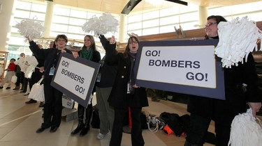 Winnipeg Blue Bombers fans and airport staff cheer as players prepared to leave Winnipeg Richardson International Airport to play in the CFL Grey Cup in Vancouver. (JASON HALSTEAD, Winnipeg Sun)