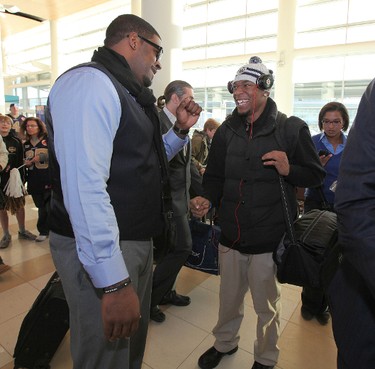 Winnipeg Blue Bombers tackle Kelly Butler (left) and QB Brandon Summers chat as players prepared to leave Winnipeg Richardson International Airport to play in the CFL Grey Cup in Vancouver. (JASON HALSTEAD, Winnipeg Sun)