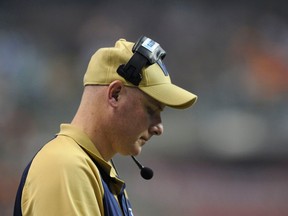 Paul LaPolice leaves the 99th Grey Cup with very little swagger Nov. 27, 2011. (REUTERS)