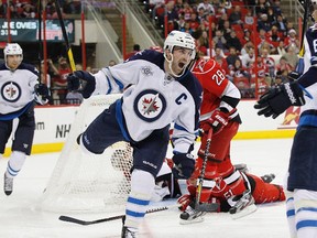 The Winnipeg Jets' Andrew Ladd celebrates after scoring a second-period goal against the Carolina Hurricanes Nov. 25, 2011 with teammate Nik Antropov (right). (REUTERS)