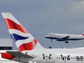 A British Airways plane flies into Heathrow Airport in west London May 12, 2011. REUTERS/Toby Melville