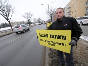 Todd Dube of Wise Up Winnipeg was out warning motorists of photo-radar enforcement just west of Grant Avenue and Nathaniel Street on Tuesday, Dec. 13, 2011. (James Turner, Winnipeg Sun)