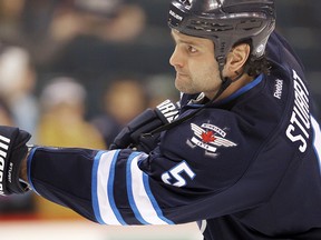 Winnipeg Jets defenceman Mark Stuart fires a shot prior to playing the Washington Capitals in NHL hockey in Winnipeg on Thursday, Dec. 15, 2011. (Brian Donogh, Winnipeg Sun)