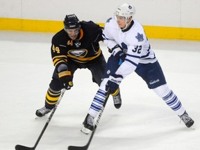 Buffalo Sabres' Andrej Sekera (L) battles Toronto Maple Leafs centre Joe Colborne in Buffalo Sept. 24, 2011.  (REUTERS/Doug Benz)