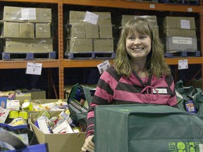 Edmonton Food Bank Resource Development Co-ordinator Kelly Cailliau stands in the Food Bank warehouse at 11508 120 Street NW in Edmonton on Thursday, Dec. 29, 2011.(CATHERINE GRIWKOWSKY  /  QMI AGENCY FILE)