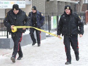Winnipeg police seal off a building at 421 Kennedy Street Sunday, Jan. 1, 2012. (BRIAN DONOGH/Winnipeg Sun)