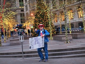 A protester affiliated with the Occupy Wall Street movement shouts slogans to invite tourists to join in the movement at Zuccotti park in New York December 3, 2011. REUTERS/Eduardo Munoz Alvarez