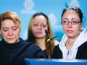 Gloria Luz, mother of murder victim Michael Pimentel, 24, joins his sister Carla Pimentel and girlfriend Jennifer De Fraga at a press conference at Toronto Police headquarters on Monday. (Ernest Doroszuk/TORONTO SUN)