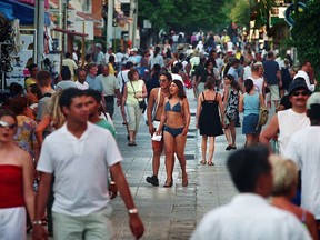 Tourists walk through the Mexican town of Playa del Carmen on the Caribbean coast. Playa is located about 68 km south of Cancun in Mexico's Yucatan Peninsula. (Jason Ransom/QMI Agency)