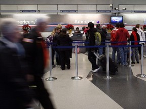 Passengers walk through American Airlines terminal 3 at O'Hare International in Chicago, December 23, 2011. REUTERS/Frank Polich