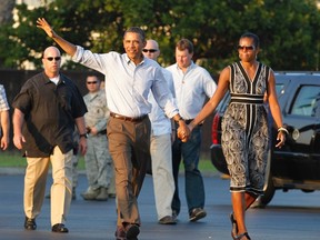 U.S. President Barack Obama and first lady Michelle Obama walk to Air Force One at Hickam Air Force base near Honolulu, Hawaii, January 2, 2012. The first family are returning to Washington after their Christmas and New Year vacation.  REUTERS/Jason Reed