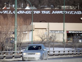 The business on the north side of the Slaw Rebchuk bridge has a new roof and a new greeting. Words on the previous roof read, "Welcome To The North End: People Before Profits", the new roof's greeting is simply "Welcome To The North End". (Chris Procaylo, Winnipeg Sun)