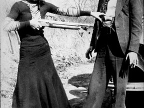 The outlaws Bonnie Parker and Clyde Barrow joke around with weapons in 1932 file photo. (File Photo)