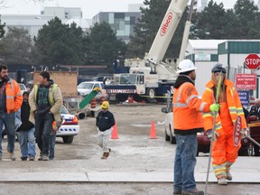 Police and emergency officials join crew at scene of accident that trapped workers at York University subway construction site Friday morning. (STAN BEHAL/Toronto Sun)