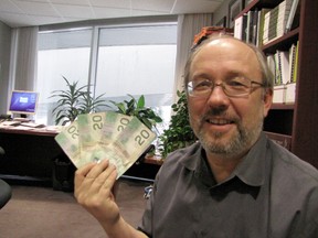 Councillor Joe Mihevc holds up the cash he won from Mayor Rob Ford in the City Hall football pool Thursday. (DON PEAT/TORONTO SUN)