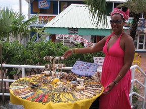 A vendor sells trinkets in Bridgetown, Barbados. Few people spend time in the capital, which was recently designated a historic site by UNESCO. (DIANE SLAWYCH/QMI Agency)