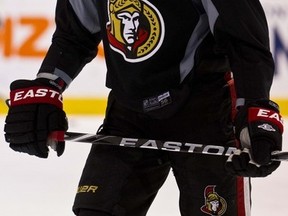 Sergei Gonchar lost a bet when Russia lost in the final to Sweden at the world junior championship and had to wear a yellow helmet at Senators practice on Friday. (Errol McGihon, Ottawa Sun)