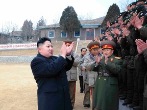 North Korea's new leader Kim Jong-un, left, applauds as he visits the Seoul Ryu Kyong Su 105 Guards Tank Division of the Korean People's Army (KPA) in Pyongyang, in this picture released by KCNA January 1, 2012. (REUTERS/KCNA)