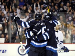 A proposed realignment plan that would have put the Winnipeg Jets in a conference with teams like Chicago, St. Louis and Minnesota hit a roadblock Friday when the NHLPA blocked it.