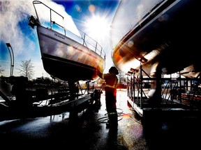Conroy ford enjoyed the promise of winter sunshine to put a shine on the hull of one of the exhibits at this year's Toronto International Boat Show (CRAIG ROBERTSON/Toronto Sun).