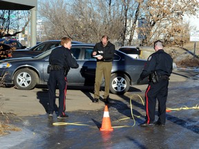 Police investigates the area of 122 Avenue and 66 Street in Jan. 7 after reports of gunshots and police found bullet casings in the alley.  PERRY MAH/EDMONTON SUN  QMI AGENCY