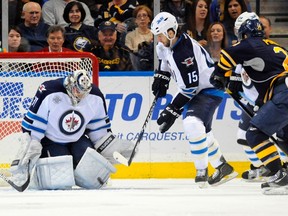 Winnipeg Jets goalie Ondrej Pavelec (31) deflects a shot as left wing Tanner Glass (15) looks on, against the Buffalo Sabres, during the first period of their NHL hockey game in Buffalo, New York January 7, 2012. REUTERS/Doug Benz