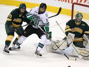 University of North Dakota Fighting Sioux forward Taylor Dickin looks for a tip in front of Clarkson University Golden Knights goaltender Paul Karpowich and Knights forward Jarrett Burton during U.S. College Hockey Classic action at the MTS Centre on Saturday.