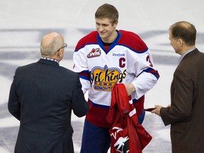 Edmonton Oil Kings Mark Pysyk, centre, shakes hands with Edmonton Oilers president Patrick LaForge, left, as the Oilers general manager Kevin Lowe looks on as Pysyk hands off his Team Canada jersey at Rexall Place in  on Saturday.
Amber Bracken, Edmonton Sun